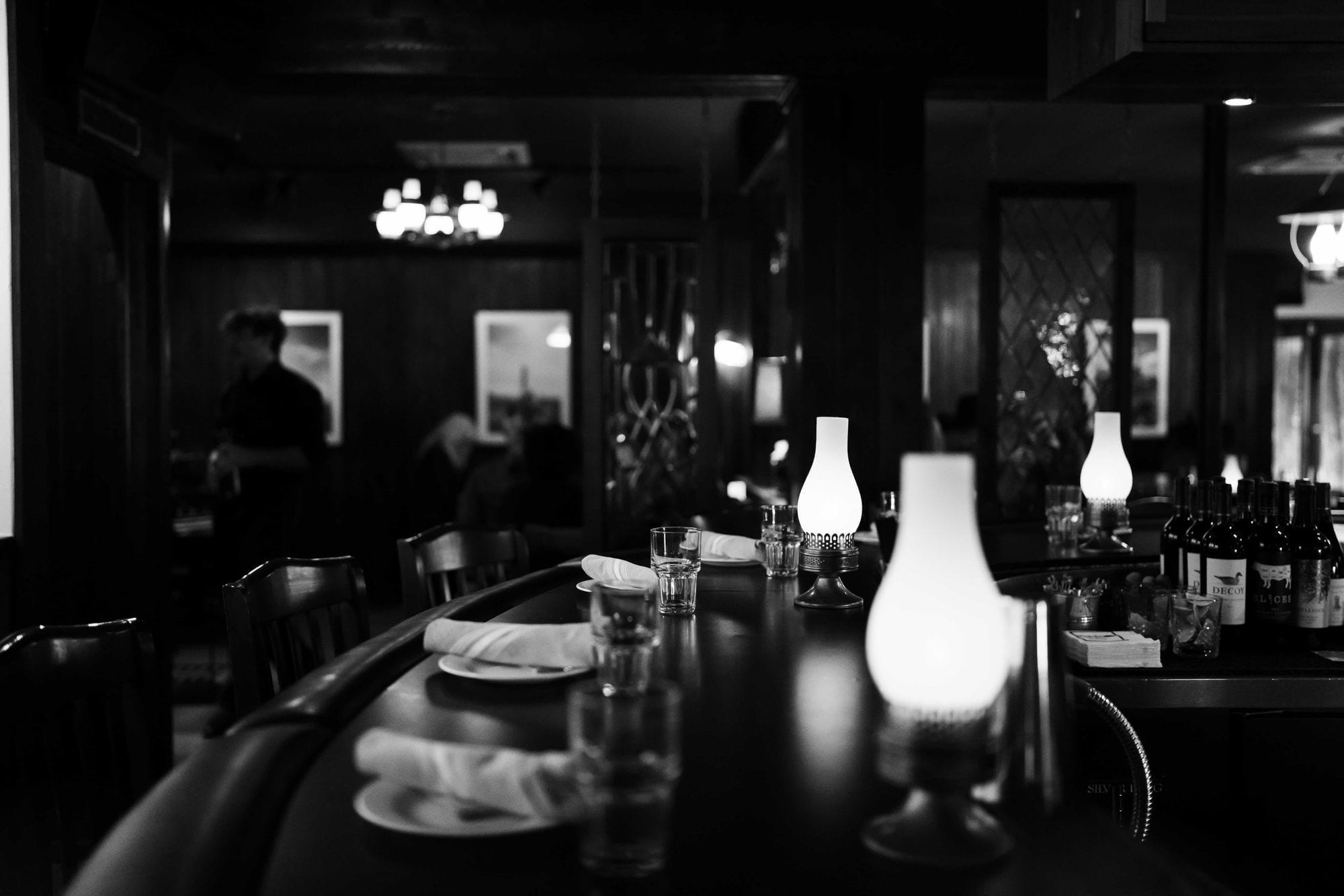 The bar at Black Hat Cattle Co — long wooden counter, taps lined up across the back wall, leather barstools pulled in close.